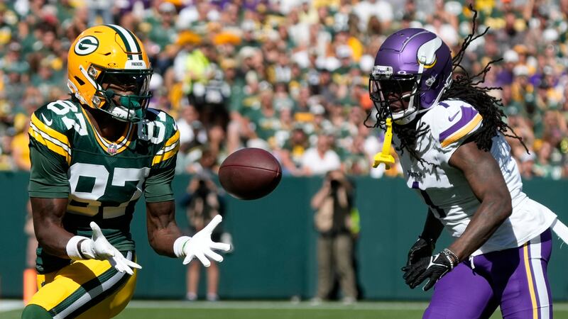 Green Bay Packers wide receiver Romeo Doubs (87) makes a catch past Minnesota Vikings...