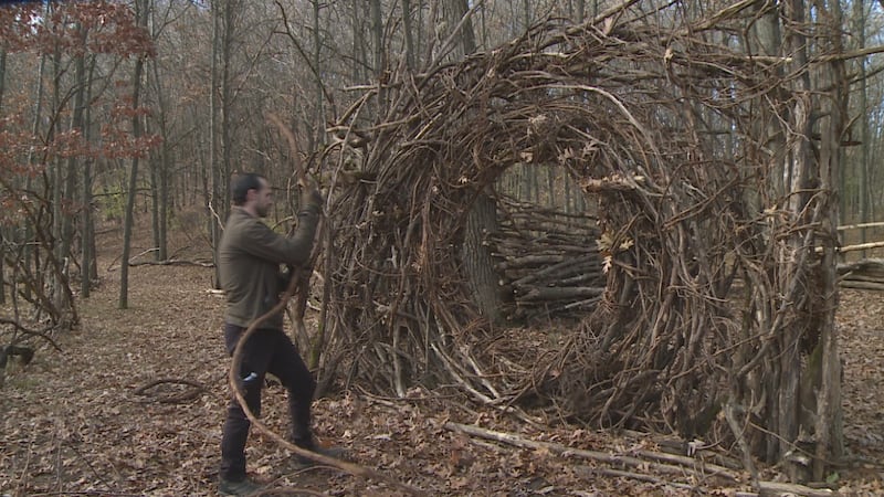 Ryan Butler working on "moon gate" at "Oak Lair" he built in Mt. Simon Park in Eau Claire, Wis.