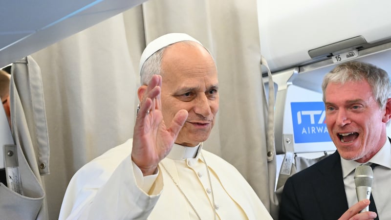 Pope Leo XIV talks to reporters aboard an aircraft on his way to Beirut, Lebanon, Sunday, Nov....
